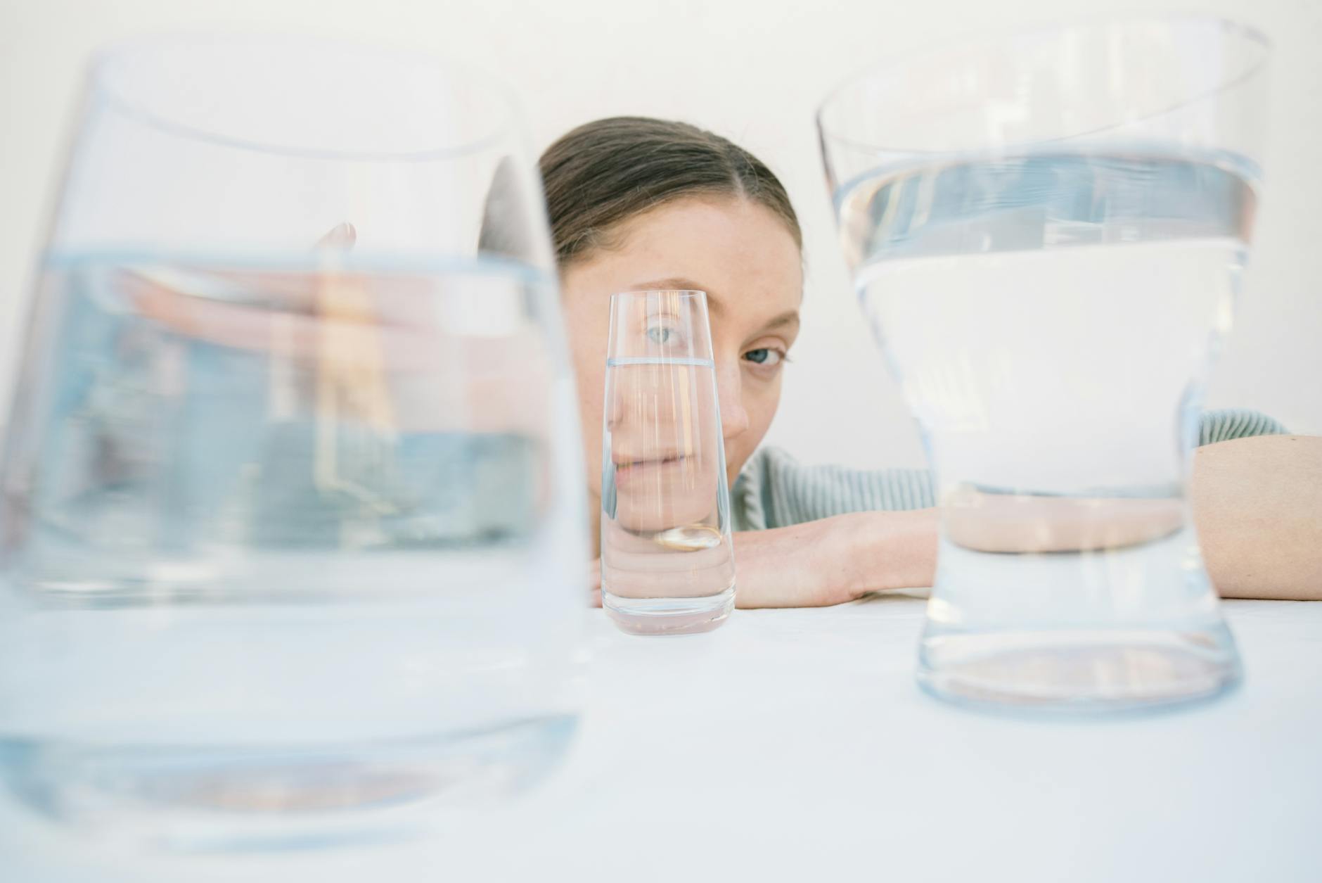 woman behind glass cups